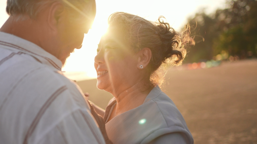 Elderly couple in loving embrace.