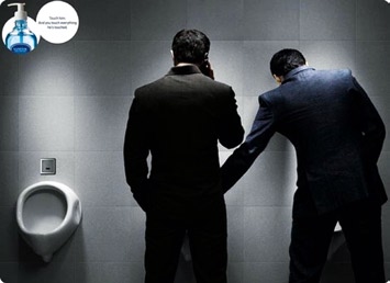 Photo of hand sanitizer campaign where one man is touching another man's intimate area in a washroom