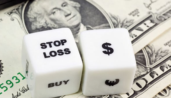 Photo of dice with the word stop and currency symbols