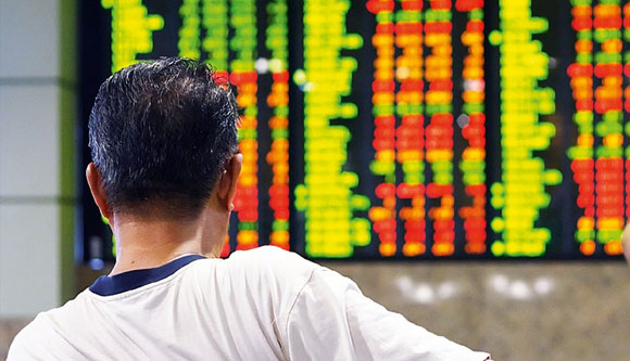 Photo of Filipino man looking at stock monitor