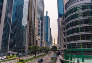 Cars on Road in Between High Rise Buildings