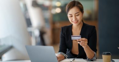 CCAP stock photo of woman looking at credit card