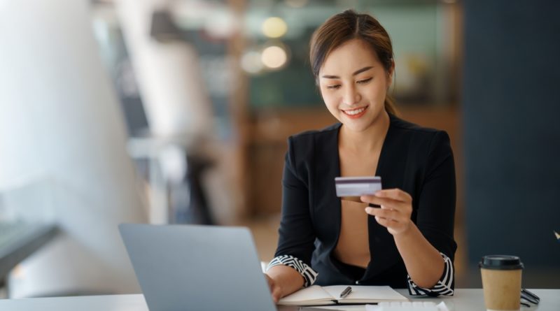 CCAP stock photo of woman looking at credit card